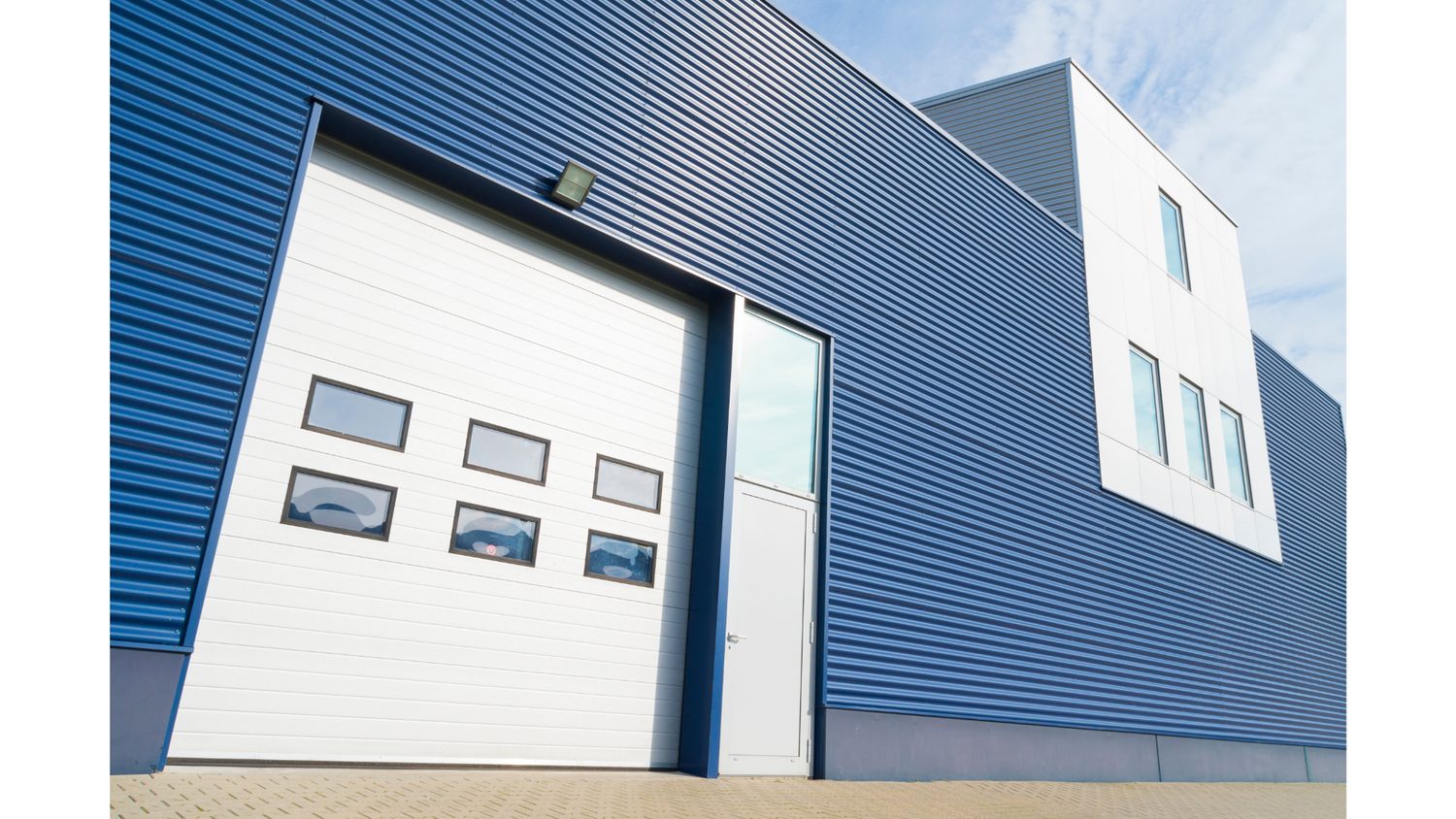 Warehouse exterior, blue with white garage door